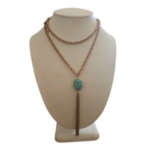 Charming Vintage Long Gold Tone Tassel Necklace with an Oval Turquoise Pendant.